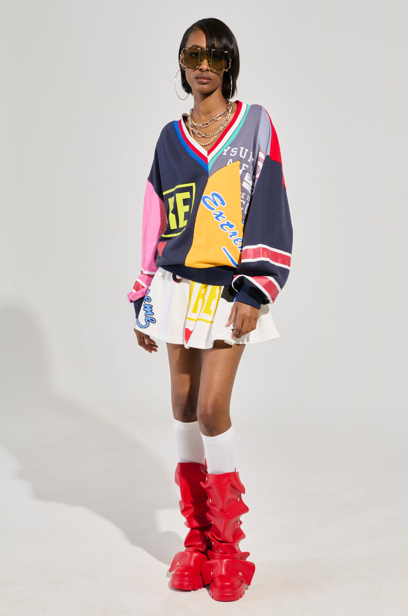 WE ARE INFINITE PLEATED MINI SKIRT